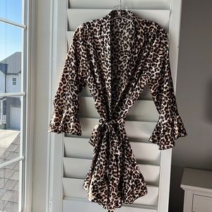 Soft animal print robe with a feminine ruffle on sleeve and bottom.